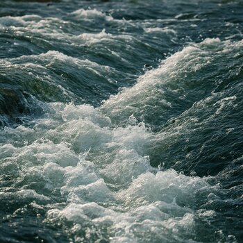 Узкое русло реки с быстрым течением и каменистыми грядами под водой